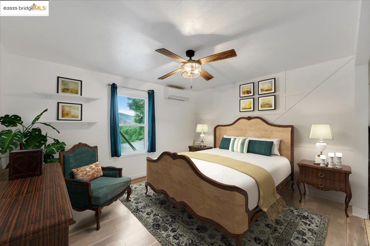 21980 Montgomery Road Sonora, CA 95370 - Photo 14 of 52 Bedroom featuring light wood finished floors, a ceiling fan, and an AC wall unit