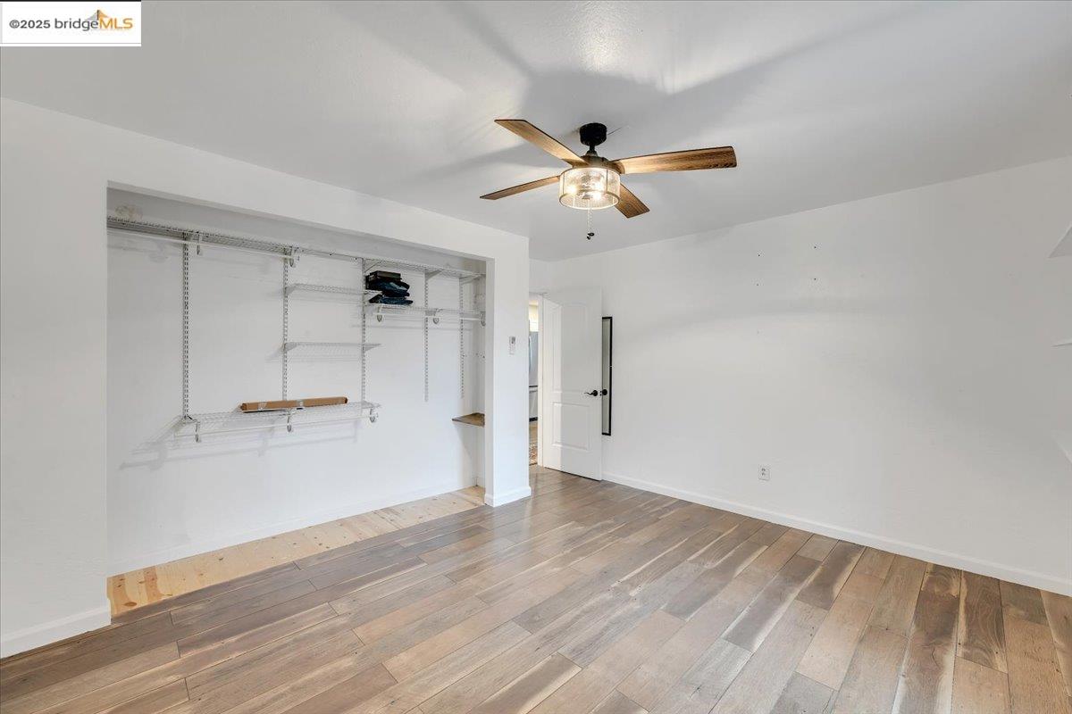21980 Montgomery Road Sonora, CA 95370 - Photo 18 of 52 an empty room with wooden floor and a ceiling fan