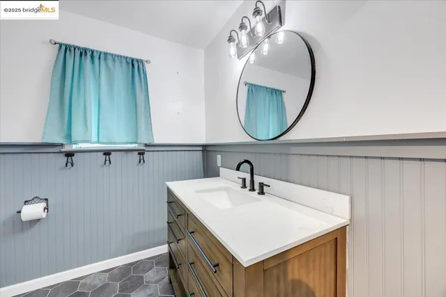 an empty room with wooden floor and a ceiling fan