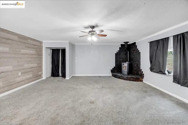 a view of an empty room with a fireplace