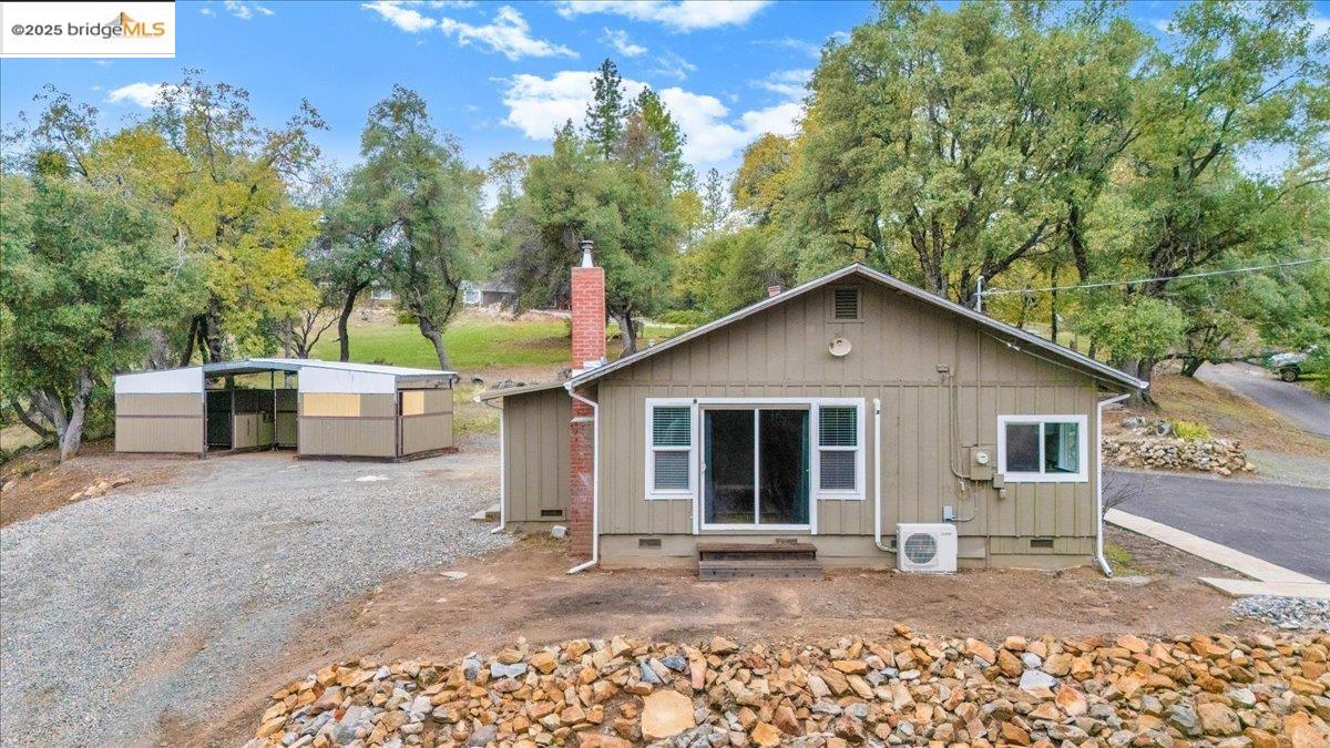 21980 Montgomery Road Sonora, CA 95370 - Photo 28 of 52 View of front of house featuring crawl space, a chimney, and an outbuilding