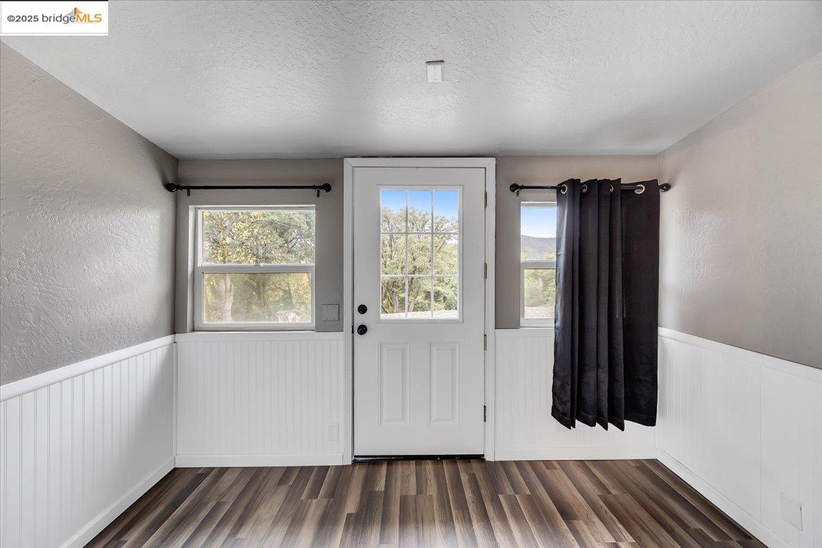 21980 Montgomery Road Sonora, CA 95370 - Photo 28 of 52 an empty room with wooden floor and windows