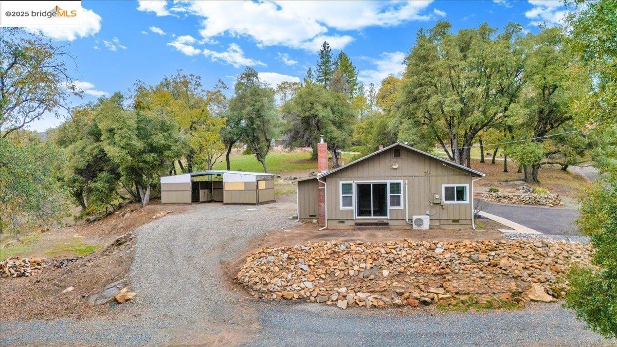 21980 Montgomery Road Sonora, CA 95370 - Photo 30 of 52 View of front facade featuring an outbuilding and a chimney
