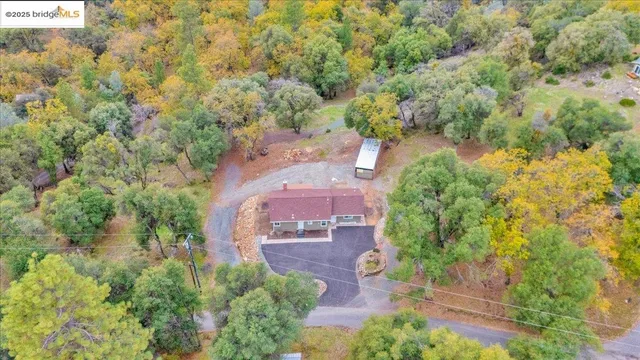 an aerial view of a house with yard