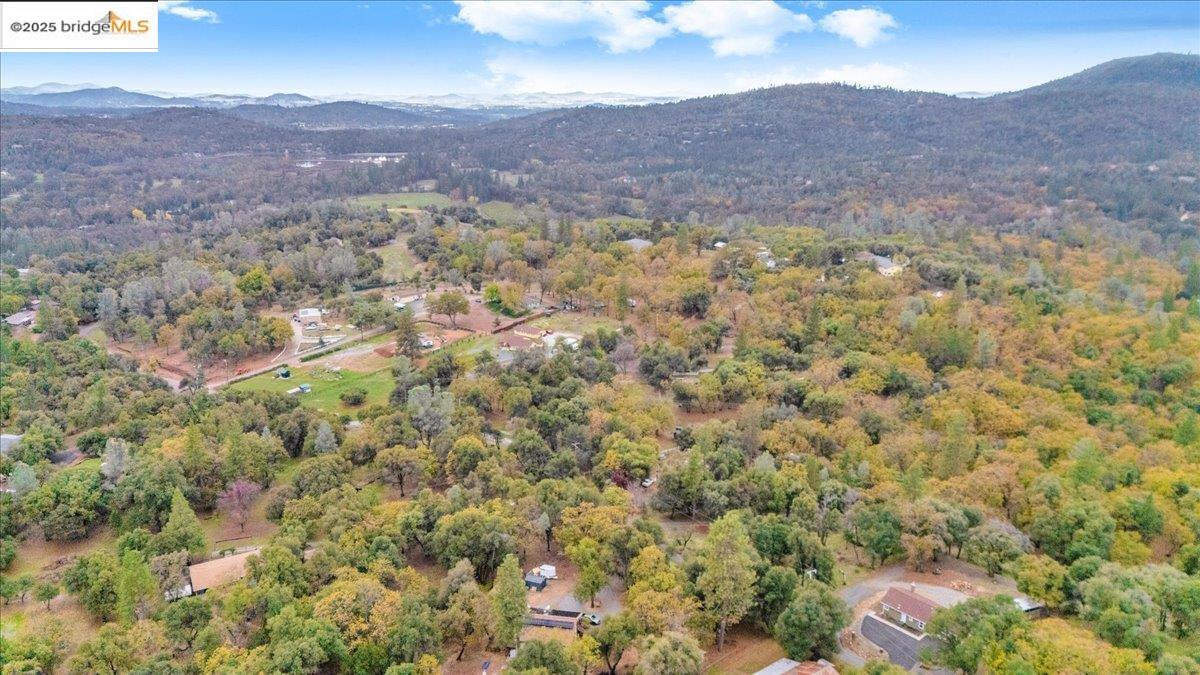 21980 Montgomery Road Sonora, CA 95370 - Photo 47 of 52 Aerial overview of property's location with a mountainous background and a heavily wooded area