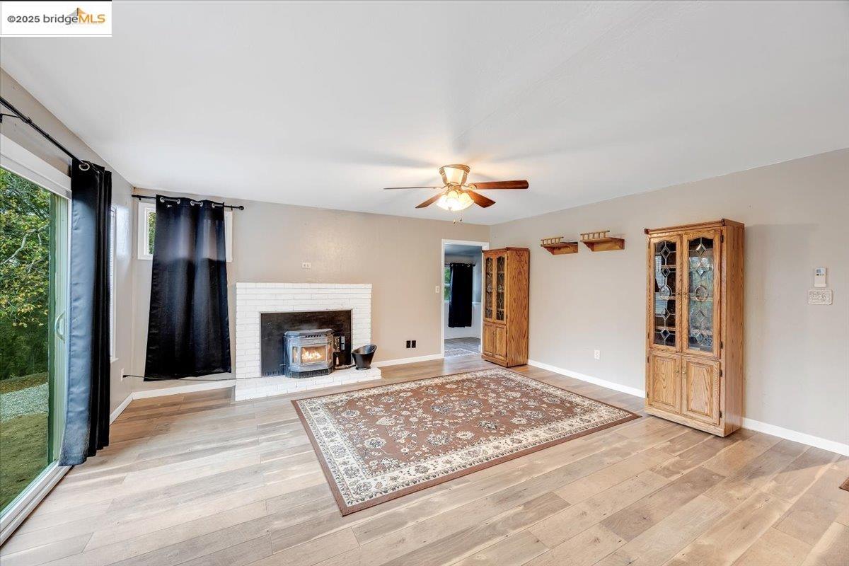 21980 Montgomery Road Sonora, CA 95370 - Photo 6 of 52 a view of an empty room with window and fire place