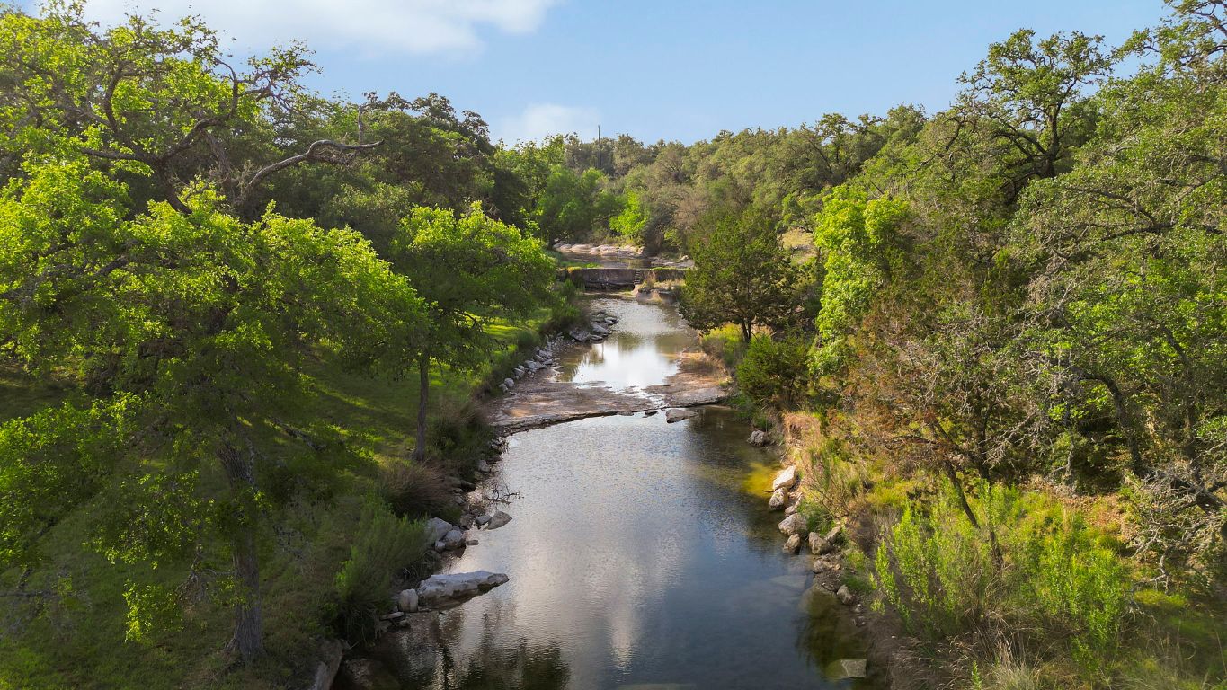 a view of a lake with a yard