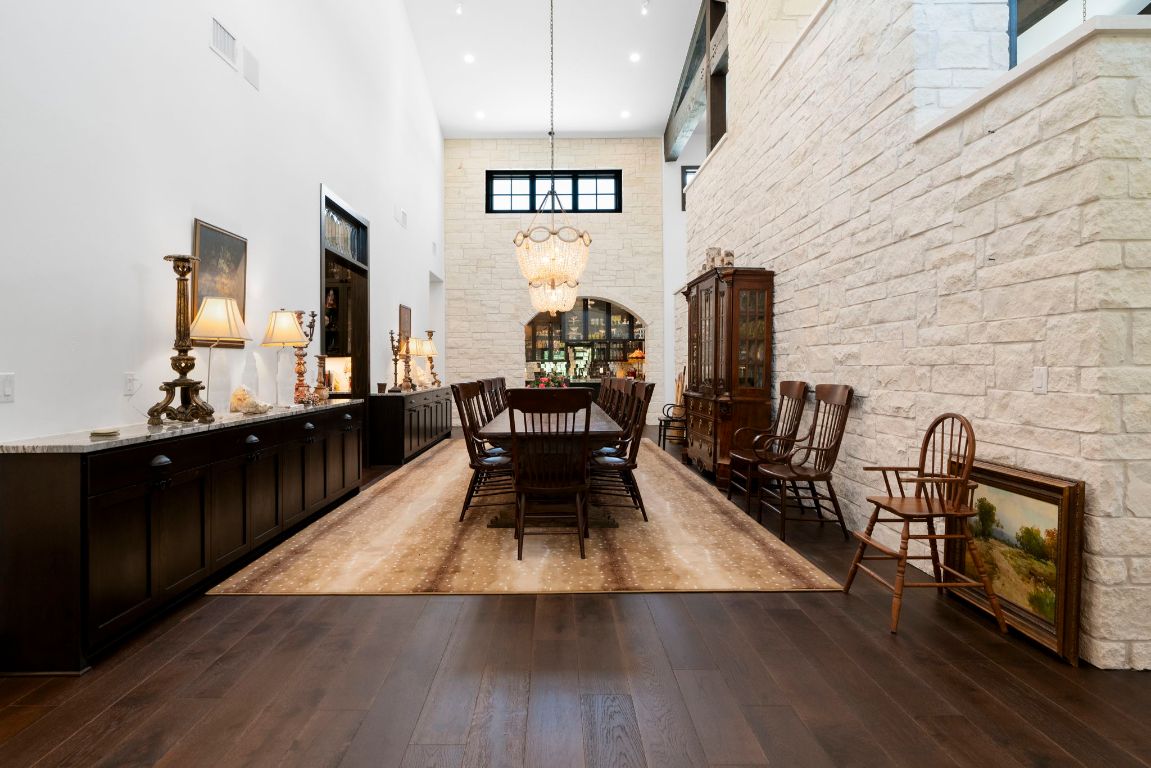 4073 Bell Springs Road Dripping Springs, TX 78620 - Photo 16 of 38 a dining room with furniture and wooden floor