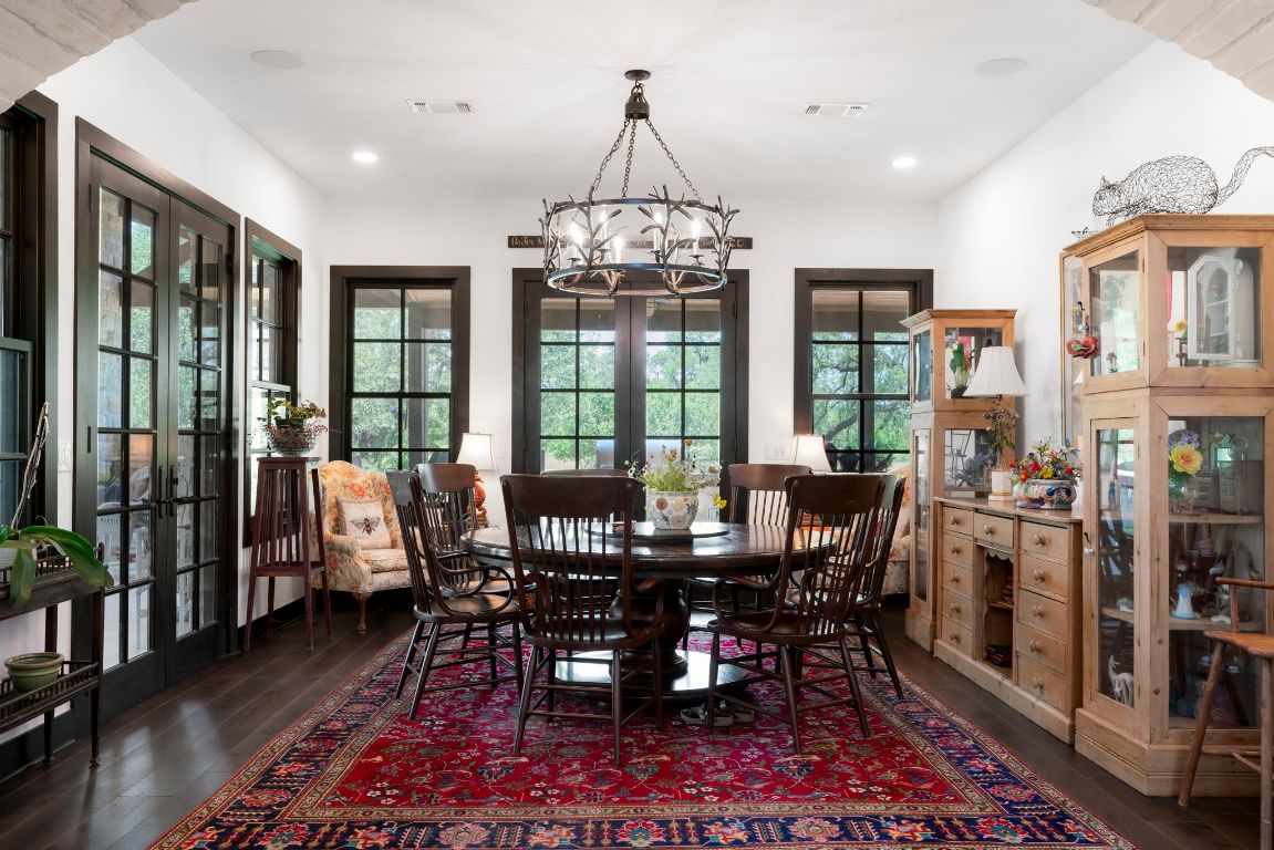 4073 Bell Springs Road Dripping Springs, TX 78620 - Photo 17 of 38 a view of a dining room with furniture window and wooden floor