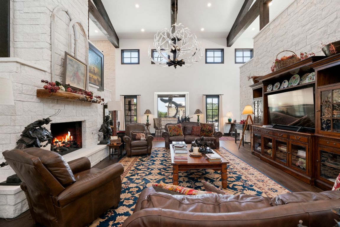 4073 Bell Springs Road Dripping Springs, TX 78620 - Photo 21 of 38 a living room with furniture a flat screen tv and a fireplace