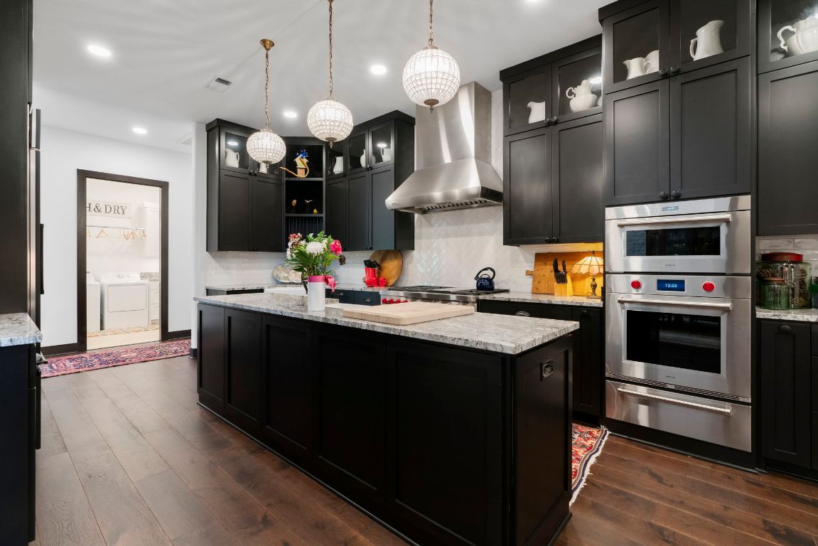 4073 Bell Springs Road Dripping Springs, TX 78620 - Photo 24 of 38 a kitchen with a sink dishwasher a stove and a refrigerator with wooden floor