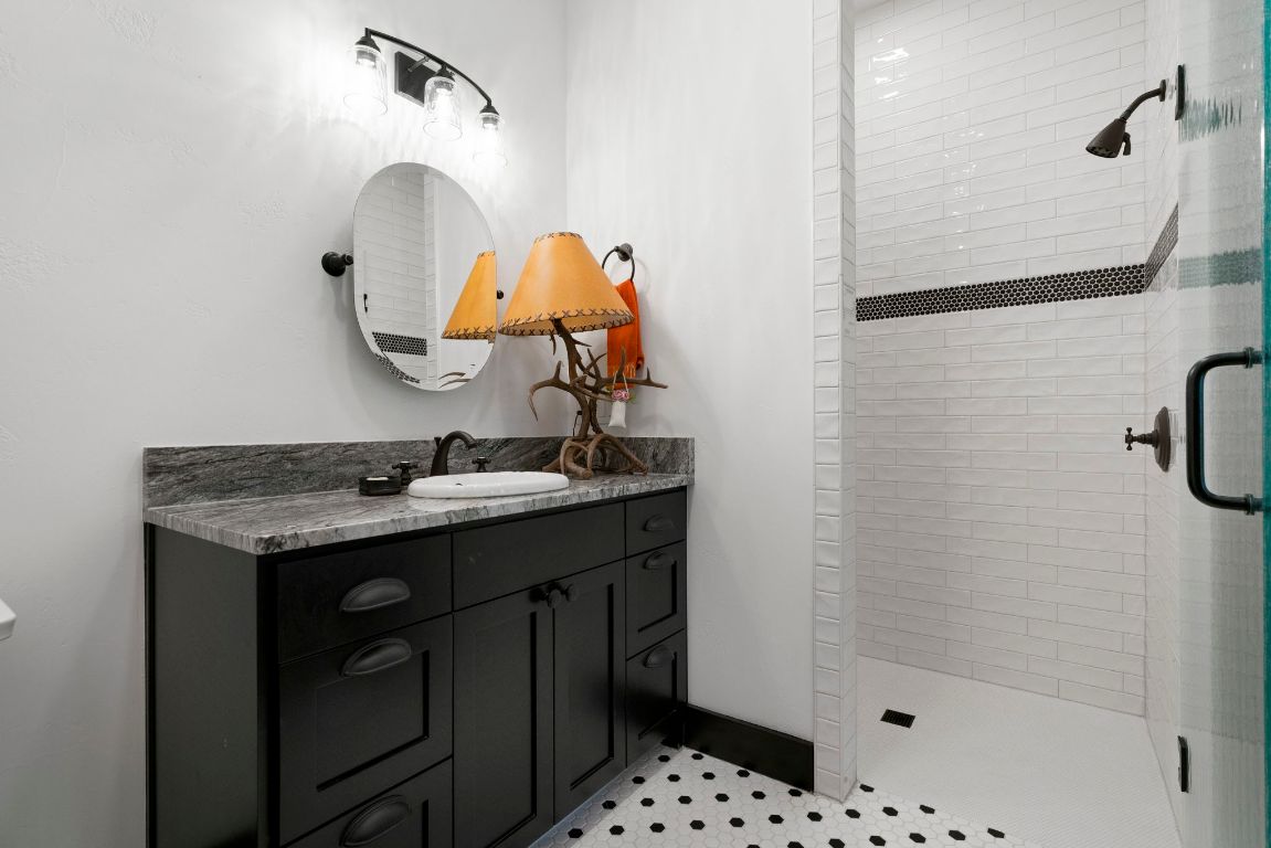 4073 Bell Springs Road Dripping Springs, TX 78620 - Photo 32 of 38 a bathroom with a sink and a mirror