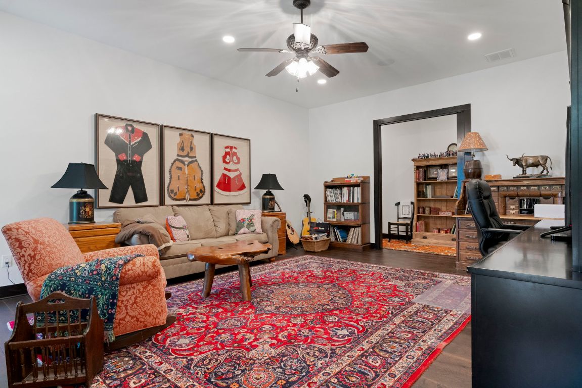 4073 Bell Springs Road Dripping Springs, TX 78620 - Photo 34 of 38 a living room with furniture a rug and a flat screen tv