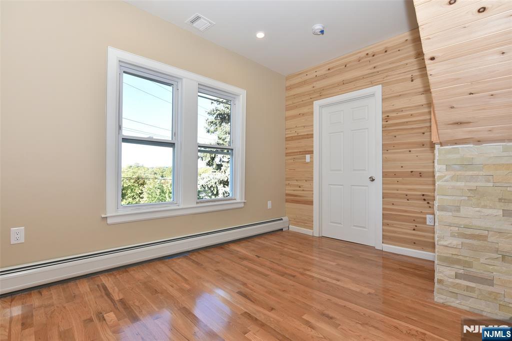 454 Park Avenue, Unit 2 Rutherford, NJ 07070 - Photo 16 of 27 an empty room with wooden floor and windows