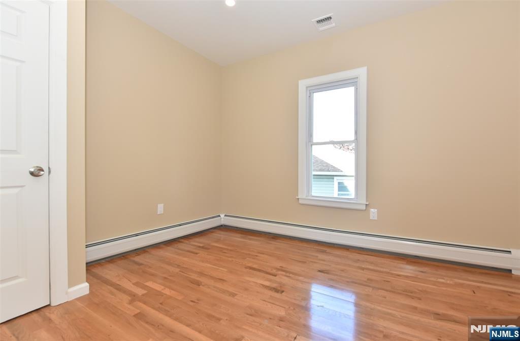 454 Park Avenue, Unit 2 Rutherford, NJ 07070 - Photo 19 of 27 a view of an empty room with wooden floor and a window