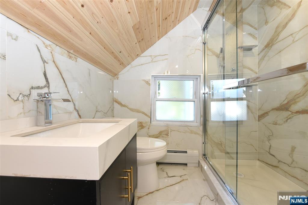 454 Park Avenue, Unit 2 Rutherford, NJ 07070 - Photo 6 of 27 a bathroom with a sink and mirror