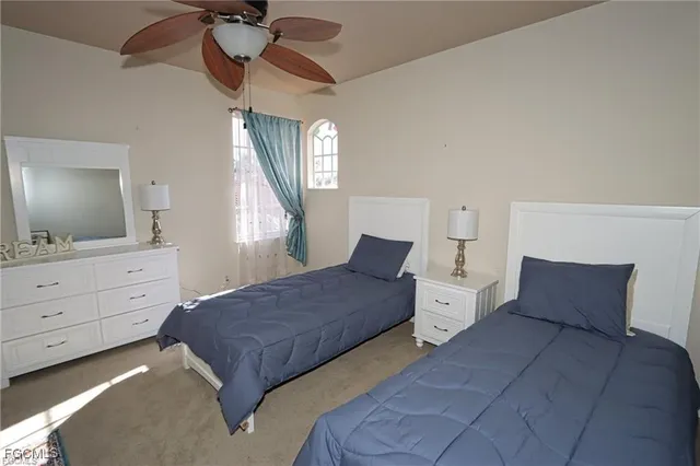 a bedroom with a large bed and a flat tv screen on dresser