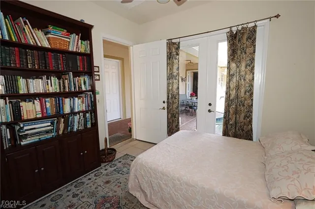 a bedroom with a large bed and a book shelf