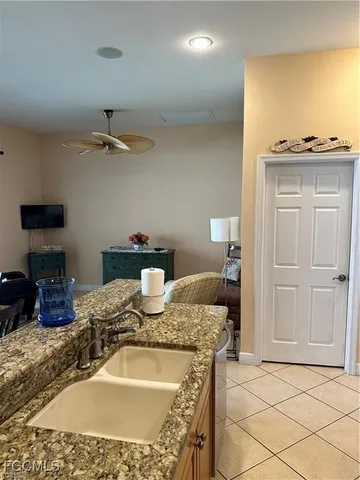a living room with granite countertop kitchen island furniture and a wooden floor
