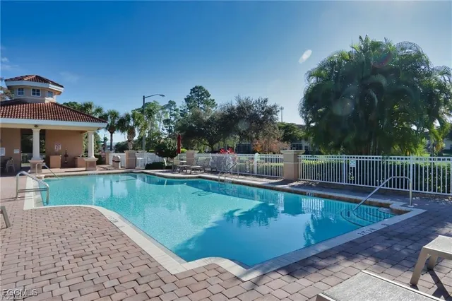 a view of a swimming pool with a table and chairs
