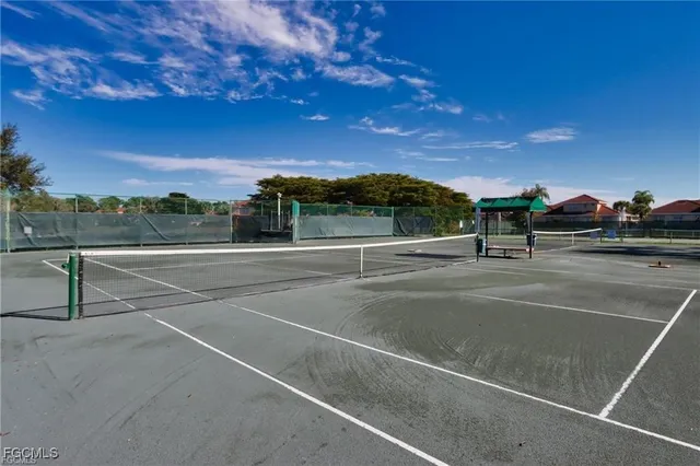 a view of a tennis court with houses