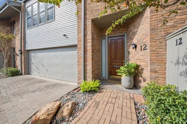 a front view of a house with potted plants