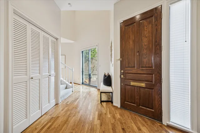 a view of a hallway with wooden floor and staircase