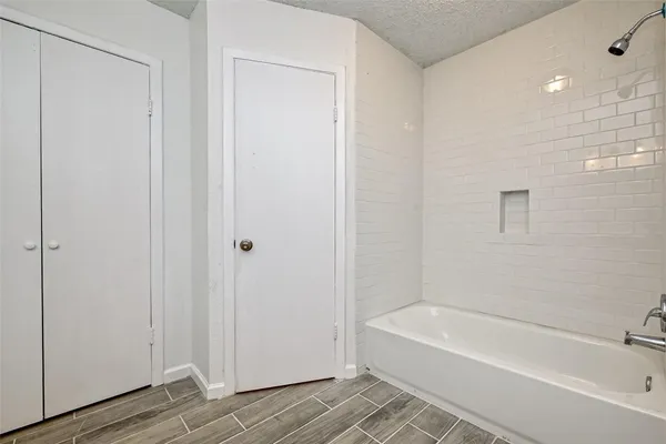 a bathroom with a bathtub and shower