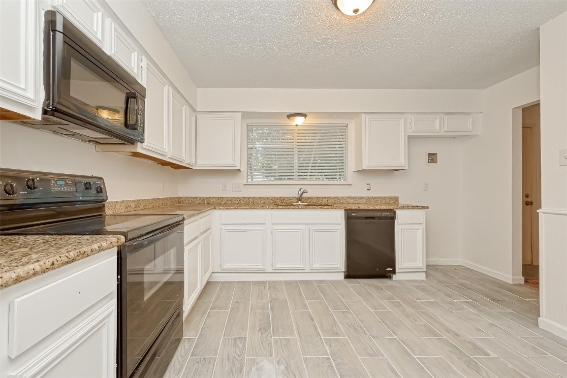 5302 Oaklynn Drive Spring, TX 77373 - Photo 4 of 15 a kitchen with stainless steel appliances granite countertop a stove a sink dishwasher and a refrigerator with wooden cabinets