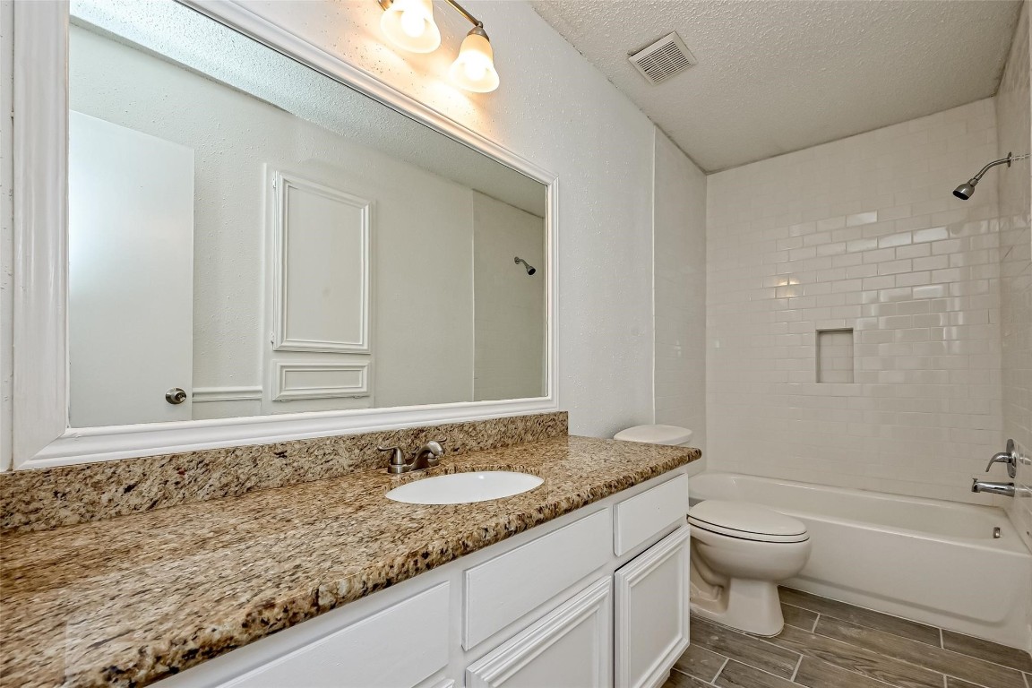 5302 Oaklynn Drive Spring, TX 77373 - Photo 10 of 15 a bathroom with a granite countertop sink a toilet and shower