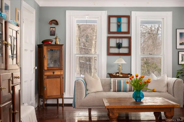 a living room with furniture and floor to ceiling windows