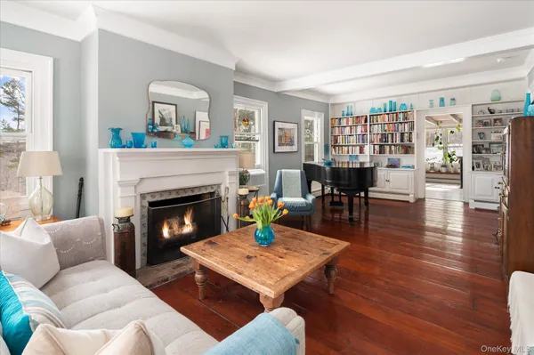 a living room with fireplace furniture and a book shelf