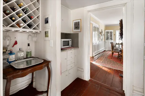 a living room with hard wood floors and a book shelf