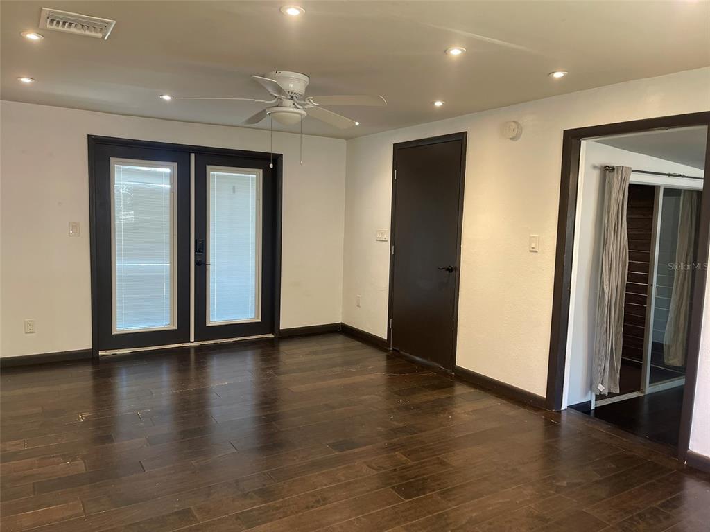 10140 Lake Louisa Road, Unit A Clermont, FL 34711 - Photo 5 of 18 an empty room with wooden floor and closet