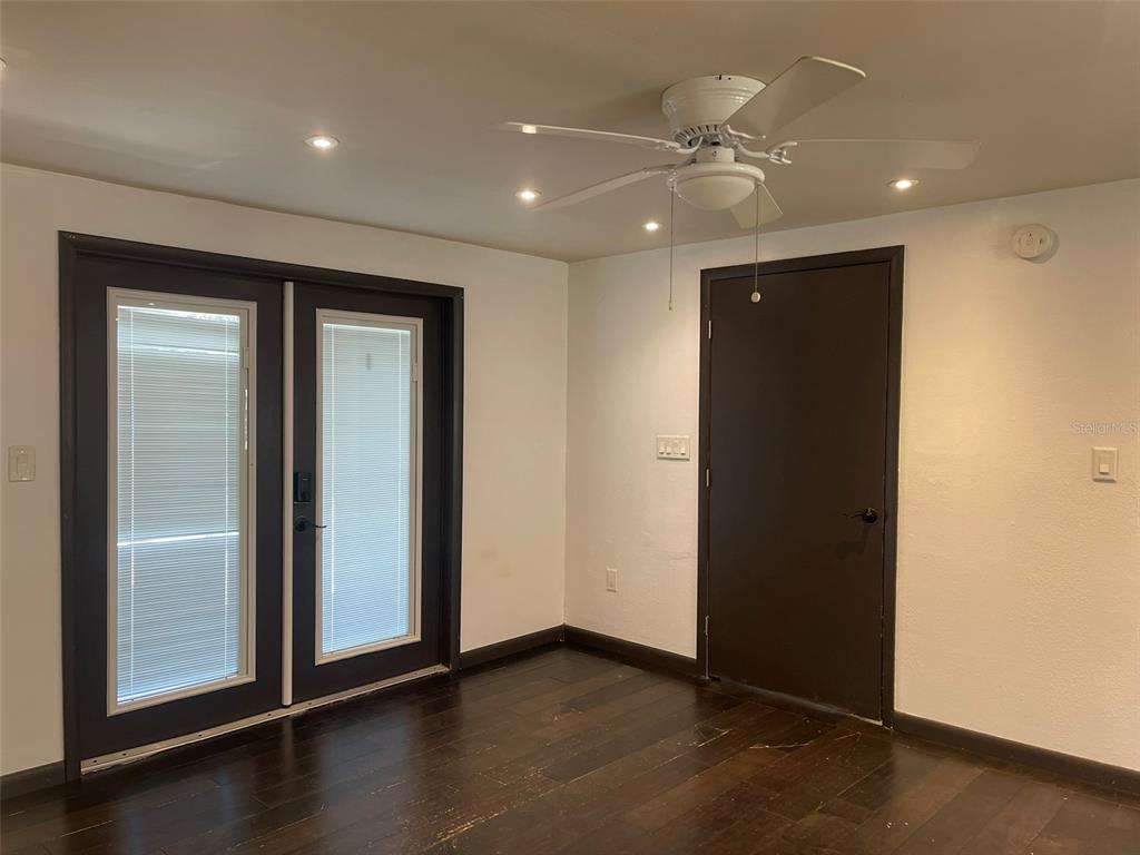 10140 Lake Louisa Road, Unit A Clermont, FL 34711 - Photo 7 of 18 an empty room with wooden floor and a hallway