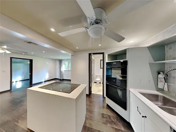 a kitchen with granite countertop a refrigerator and a sink