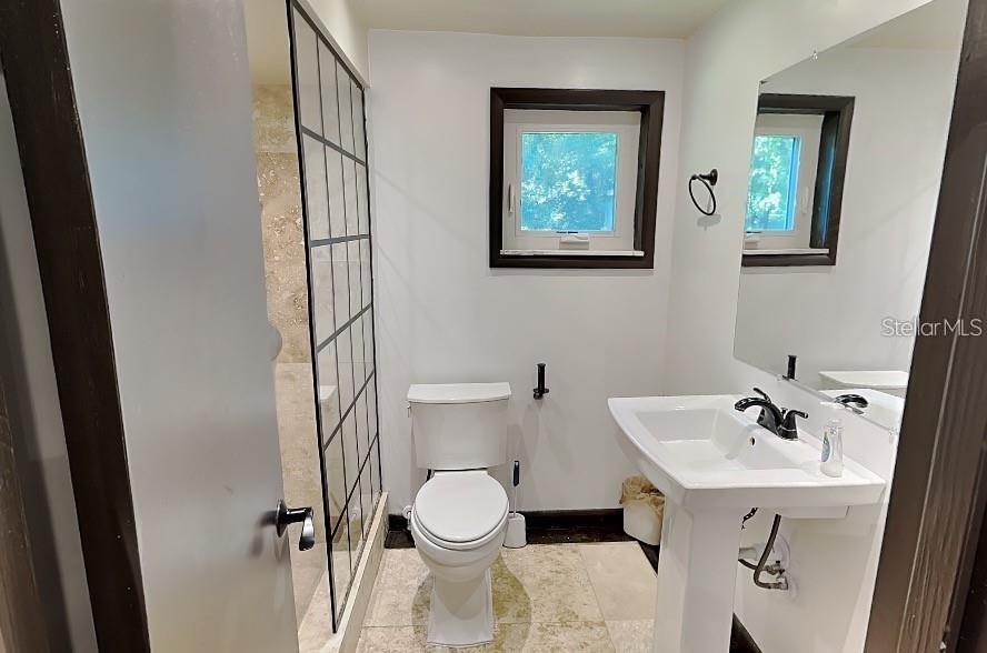 10140 Lake Louisa Road, Unit A Clermont, FL 34711 - Photo 9 of 18 a bathroom with a sink mirror and toilet