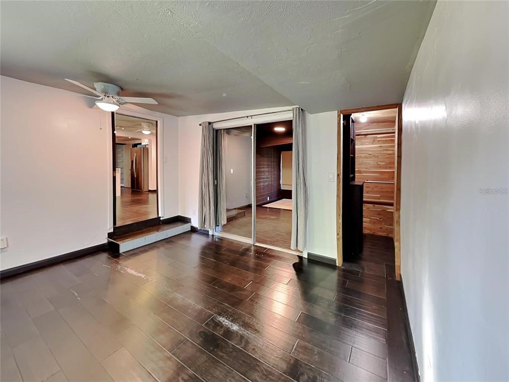 10140 Lake Louisa Road, Unit A Clermont, FL 34711 - Photo 10 of 18 an empty room with wooden floor and closet