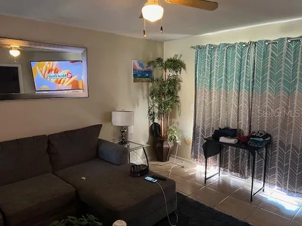 a living room with furniture and a flat screen tv