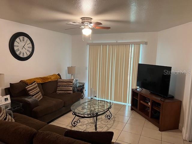 209 Ridge Crest Loop Minneola, FL 34715 - Photo 16 of 33 a living room with furniture a clock on wall and a flat screen tv