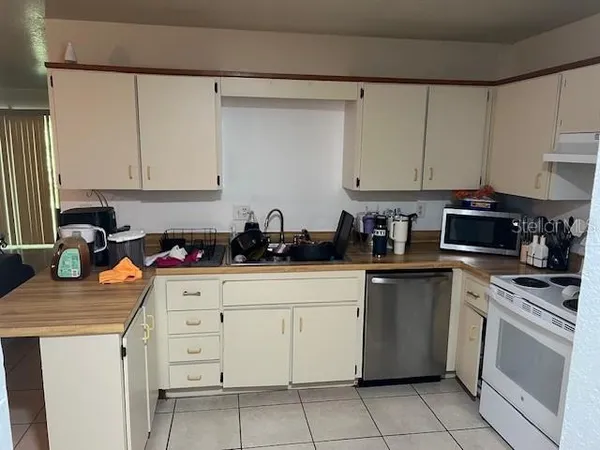 a kitchen with a sink and a stove top oven