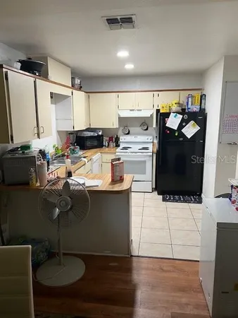 a kitchen with a sink cabinets and appliances