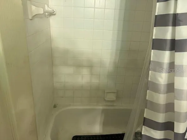 a white toilet sitting next to a shower