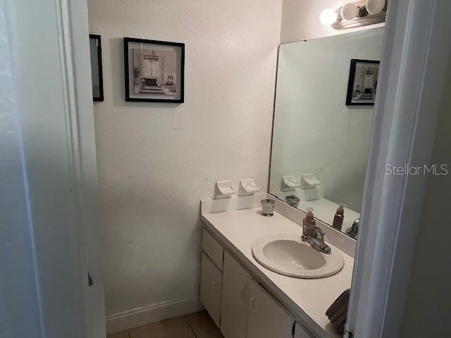 209 Ridge Crest Loop Minneola, FL 34715 - Photo 27 of 33 a bathroom with a sink and a mirror