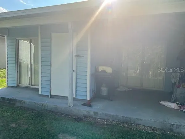 a backyard of a house with outdoor seating