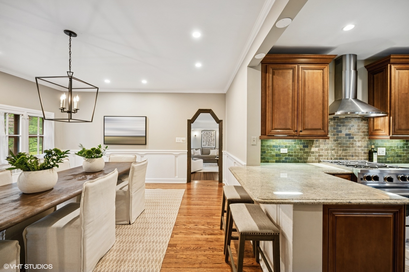 1487 Tower Road Winnetka, IL 60093 - Photo 20 of 45 a kitchen with a table chairs stove and cabinets