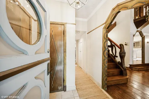 a view of a hallway with wooden floor and entryway