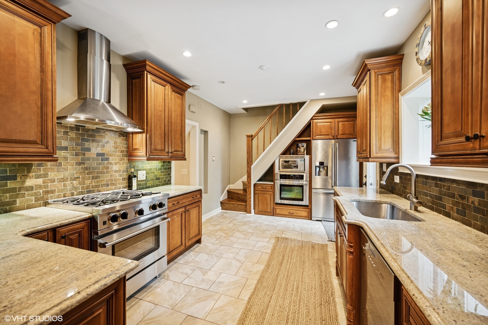 1487 Tower Road Winnetka, IL 60093 - Photo 21 of 45 a kitchen with stainless steel appliances granite countertop a sink a stove and a wooden floors