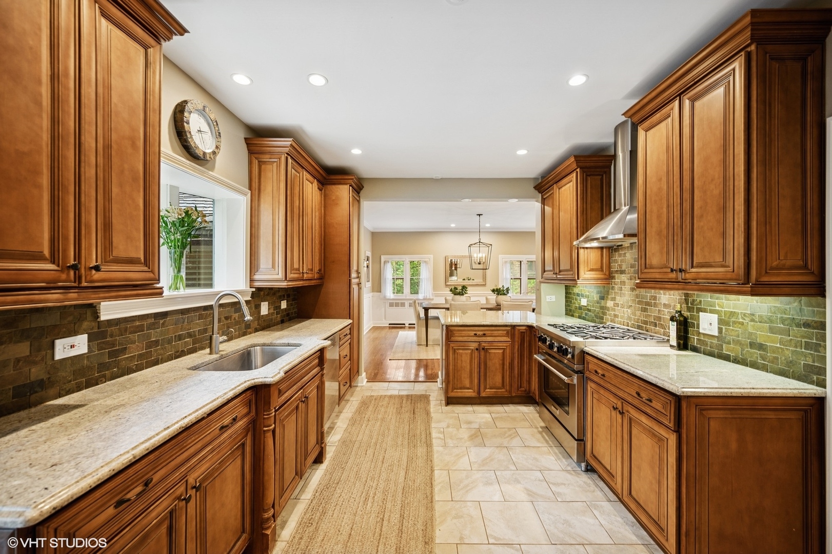 1487 Tower Road Winnetka, IL 60093 - Photo 22 of 45 a large kitchen with a large window and stainless steel appliances