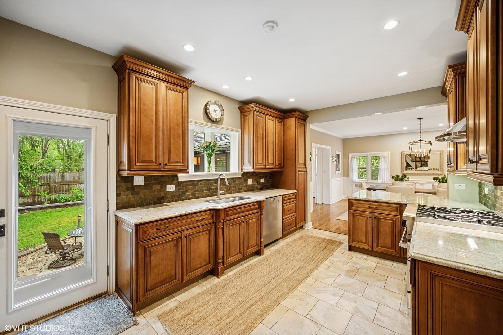 1487 Tower Road Winnetka, IL 60093 - Photo 23 of 45 a large kitchen with stainless steel appliances granite countertop a stove a sink dishwasher and a refrigerator
